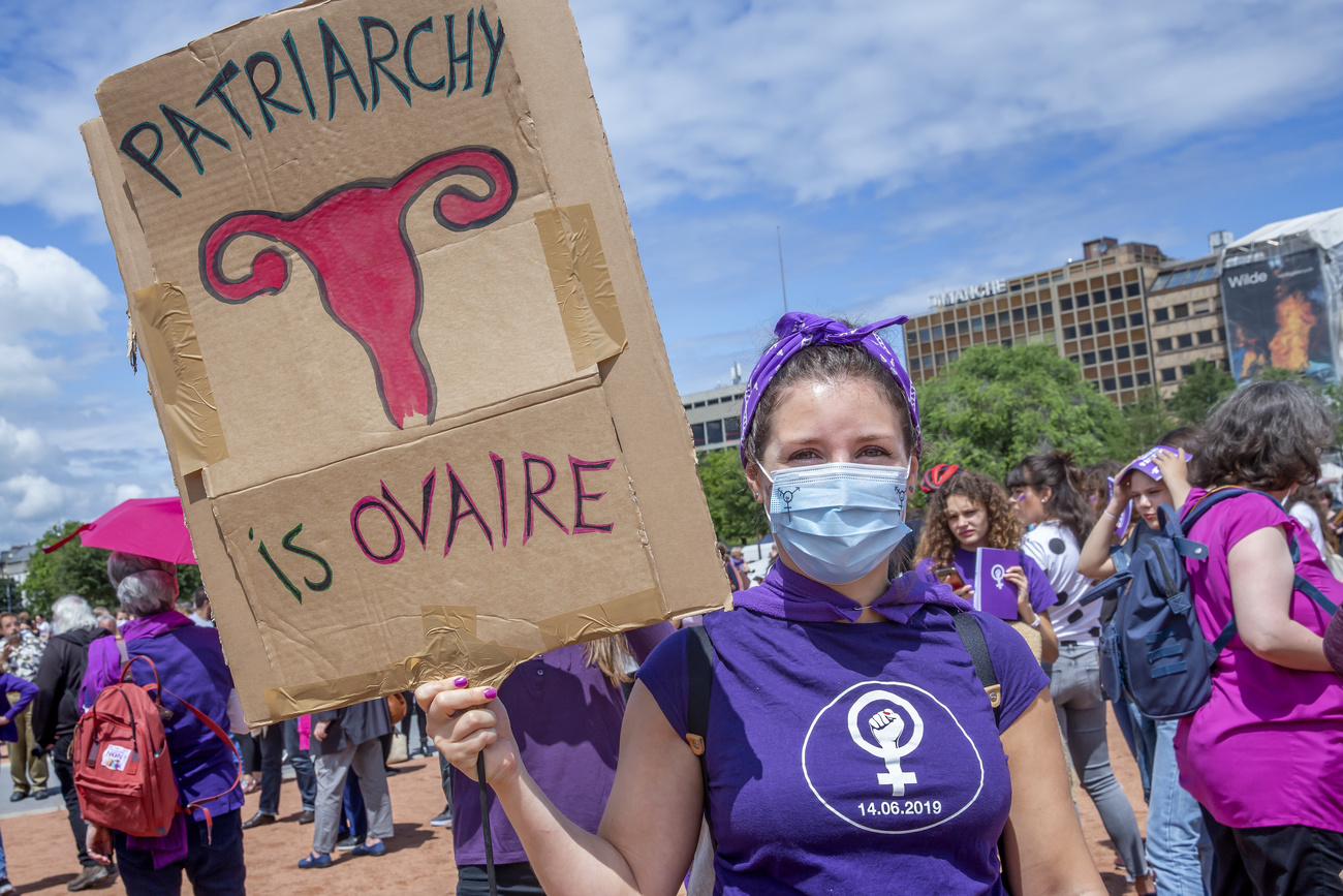 Woman at a demo holding placard