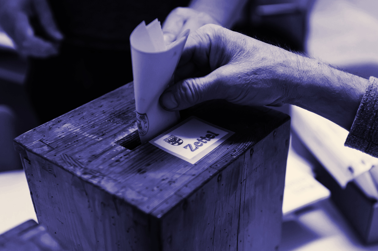 有権者が、シェルテンでの国民投票の日に投票用紙を提出しているところ。