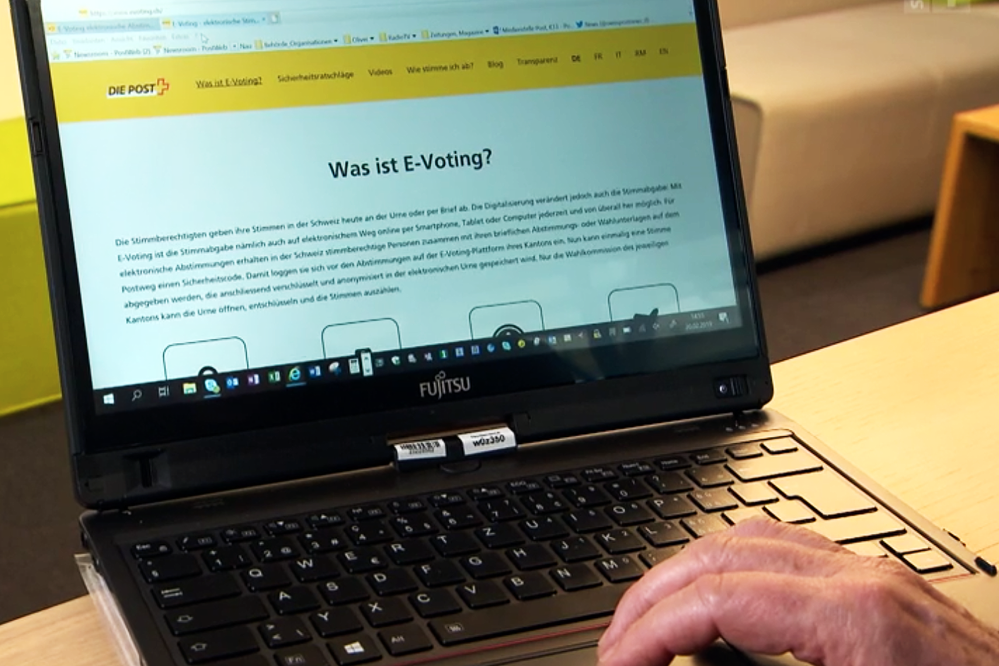 laptop showing Swiss Post logo