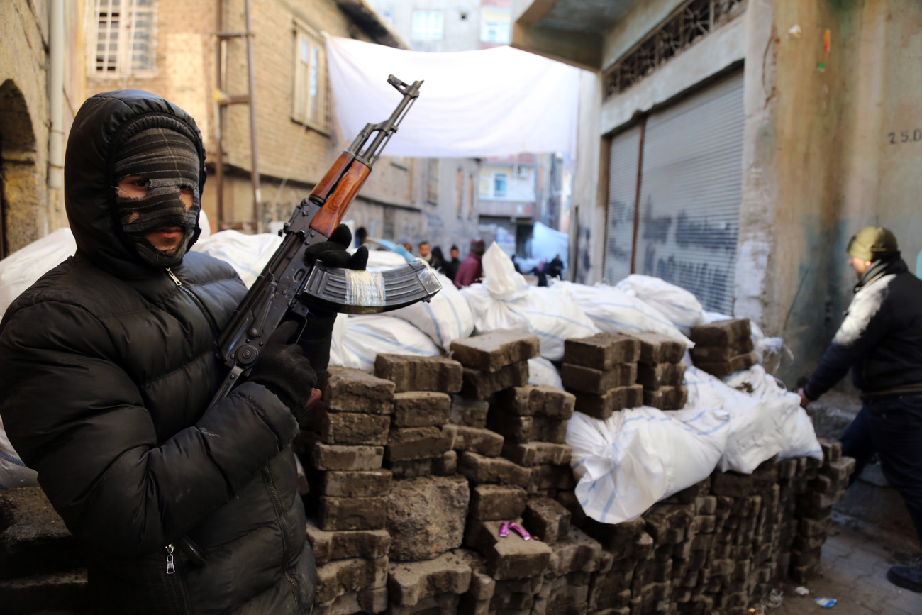 A PKK militant stands at a barricade in Diyarbakir, southeast Turkey (2016).