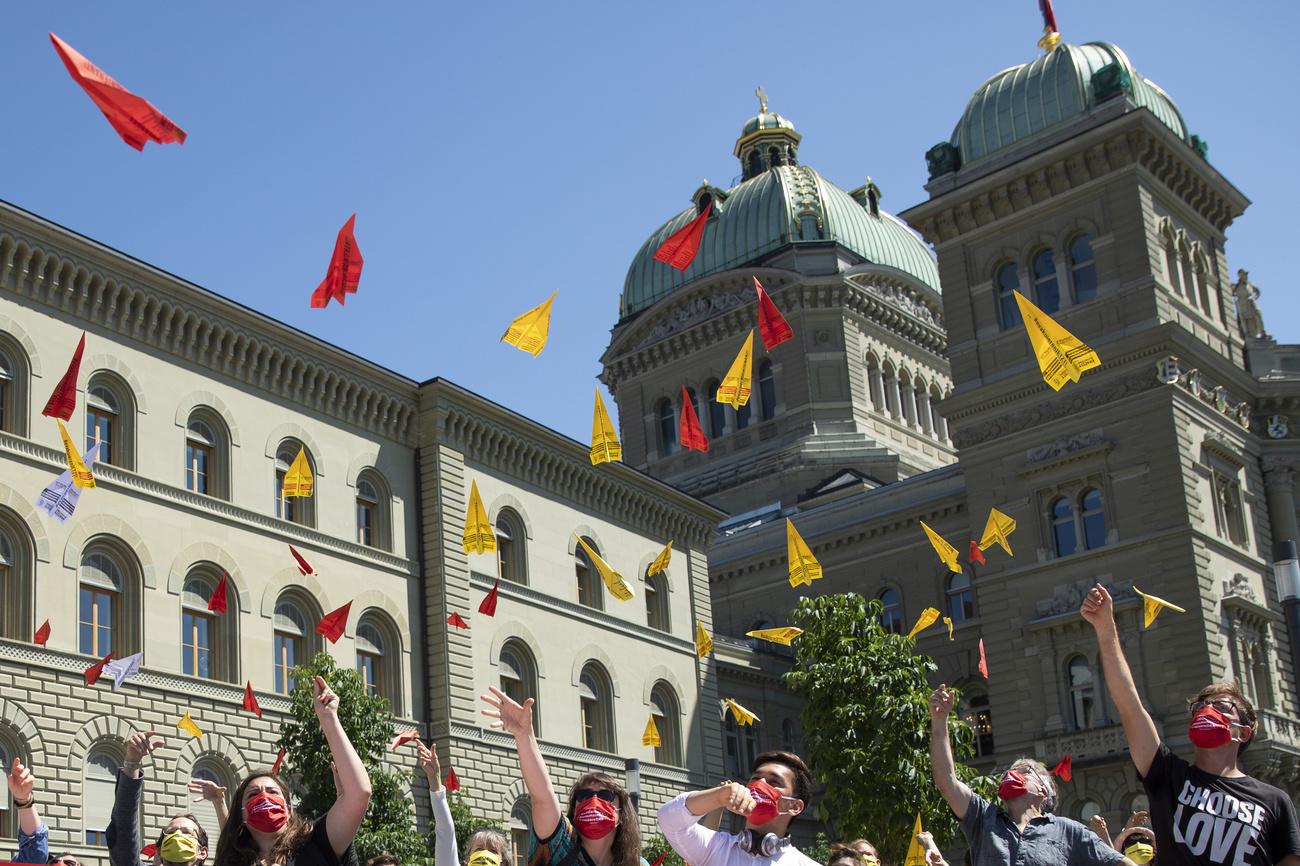 people throwing coloured paper in air