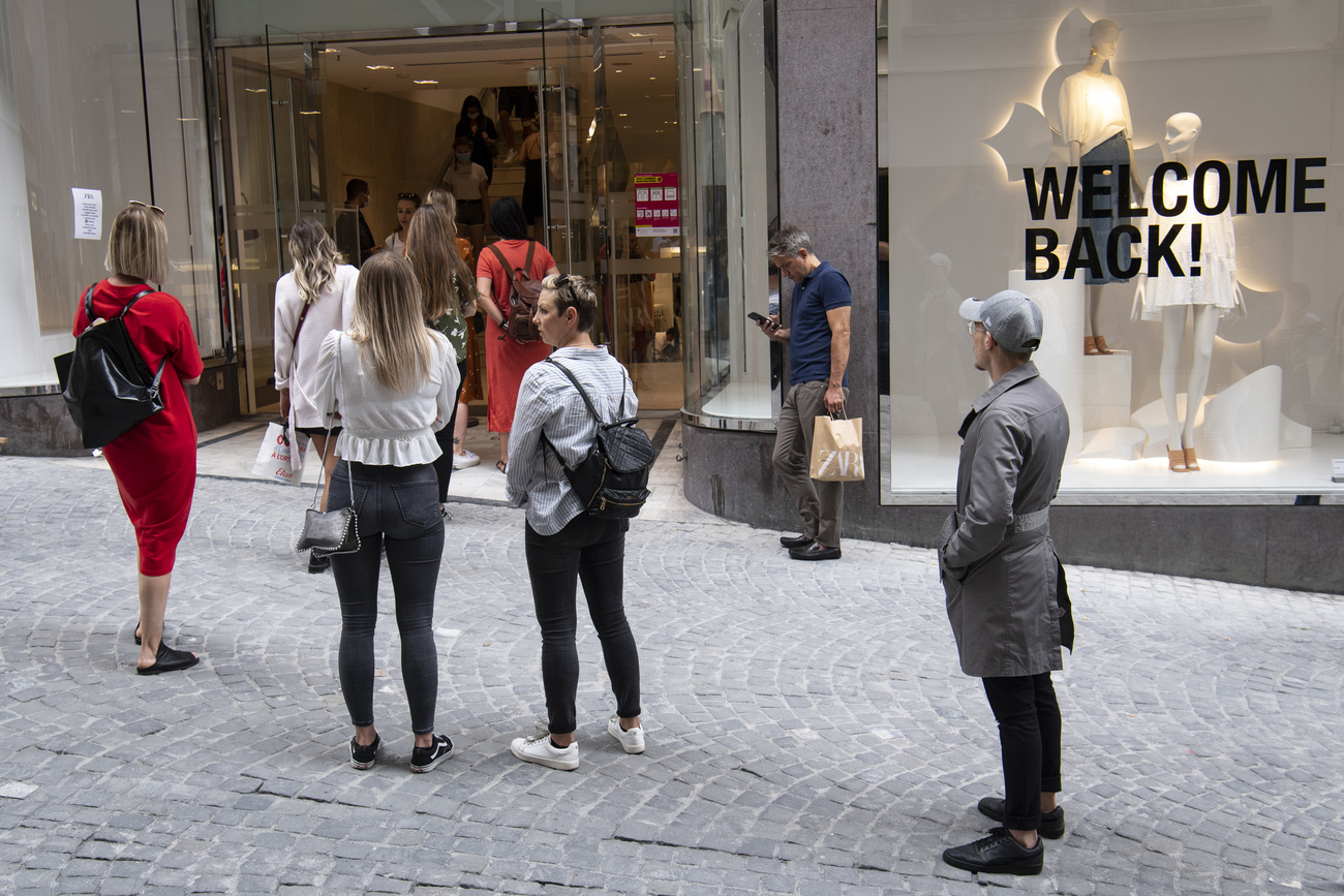 People waiting to enter shop in Lausanne