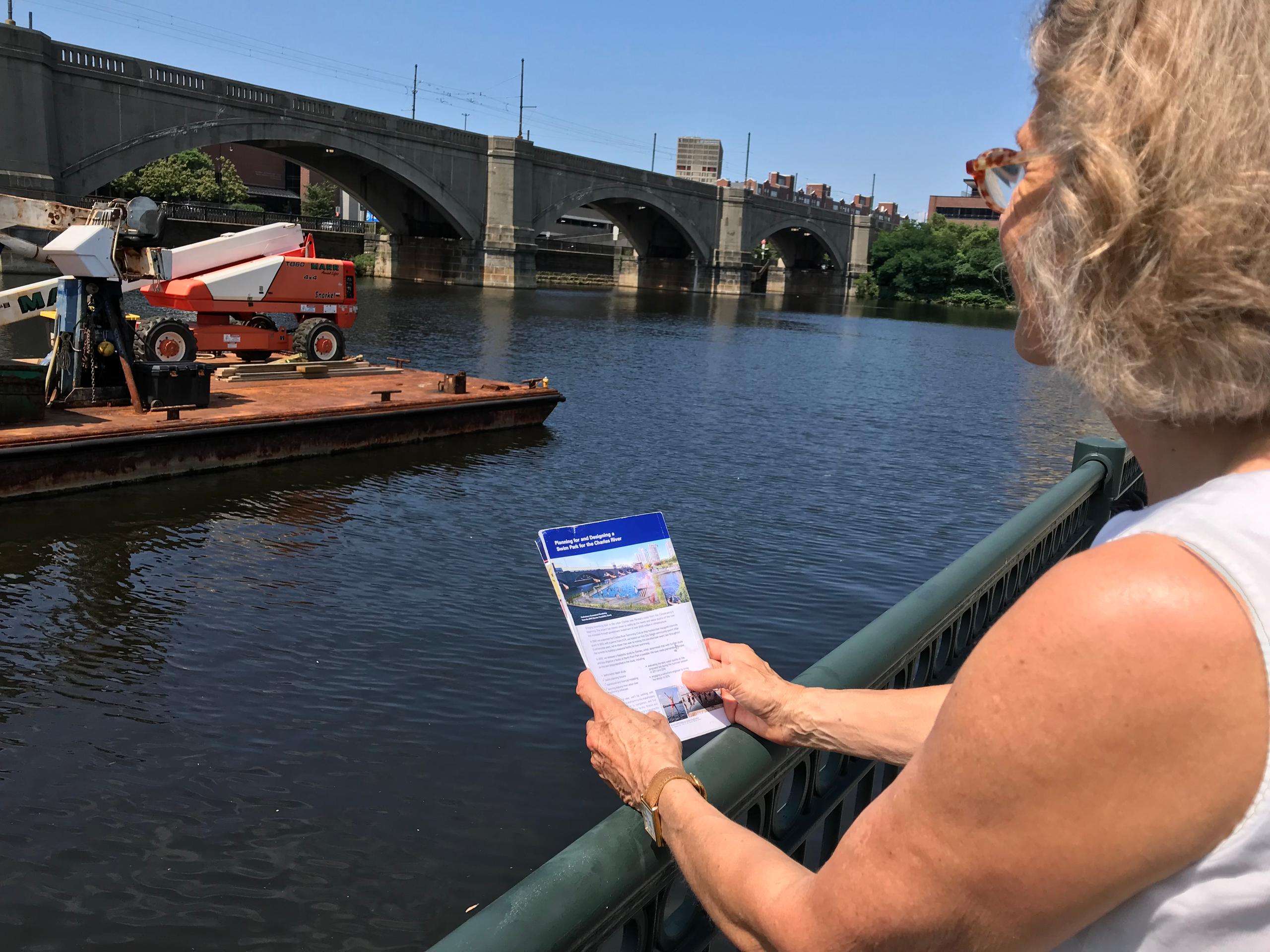 Woman with brochure at riverside