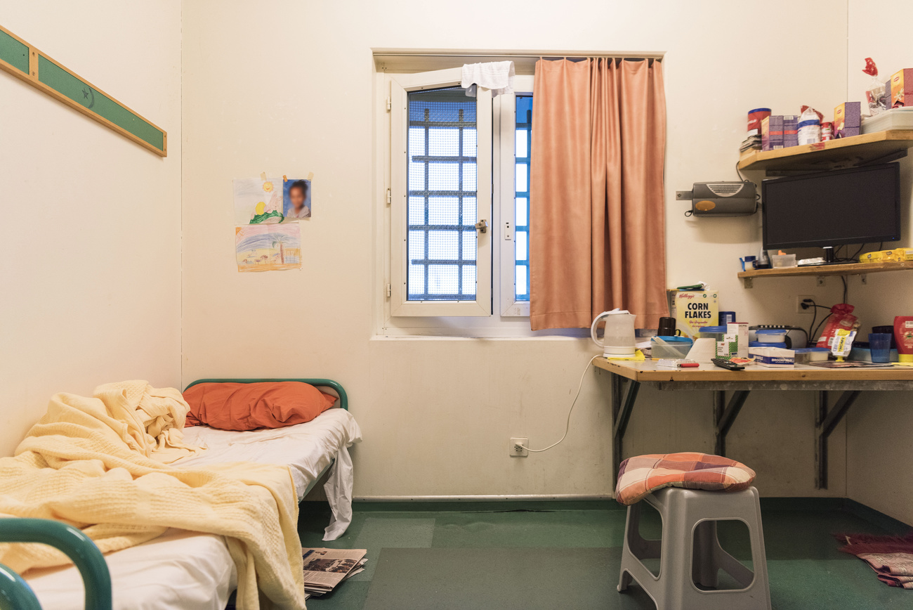 Prison cell with TV, window and groceries