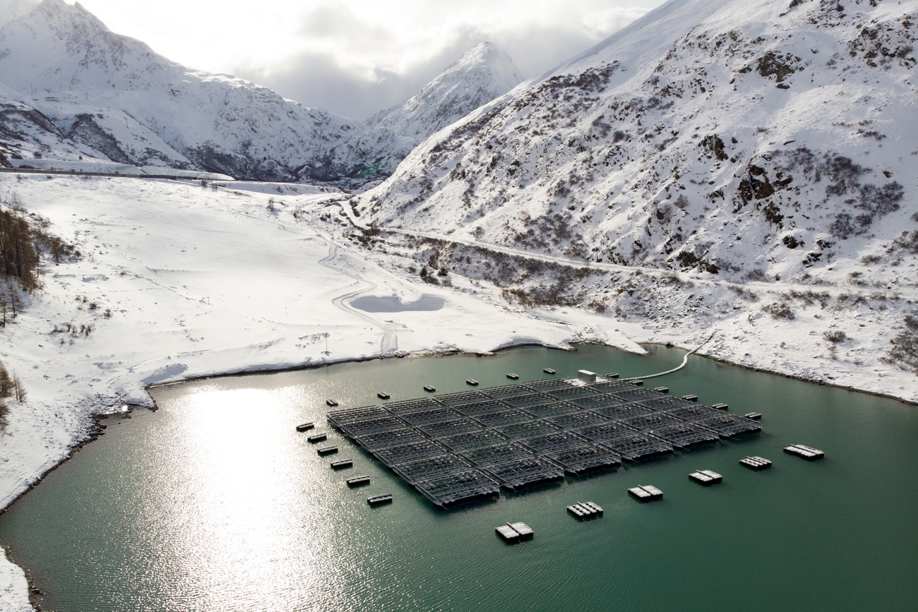 Floating barges with solar panels are pictured on the Lac des Toules