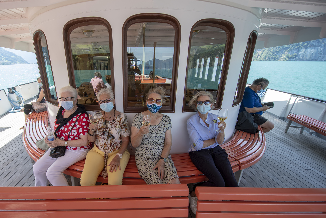People on outer boat deck wearing face masks