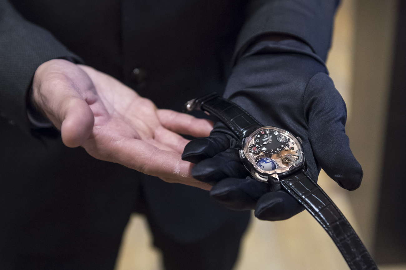 A man holding a watch with glove