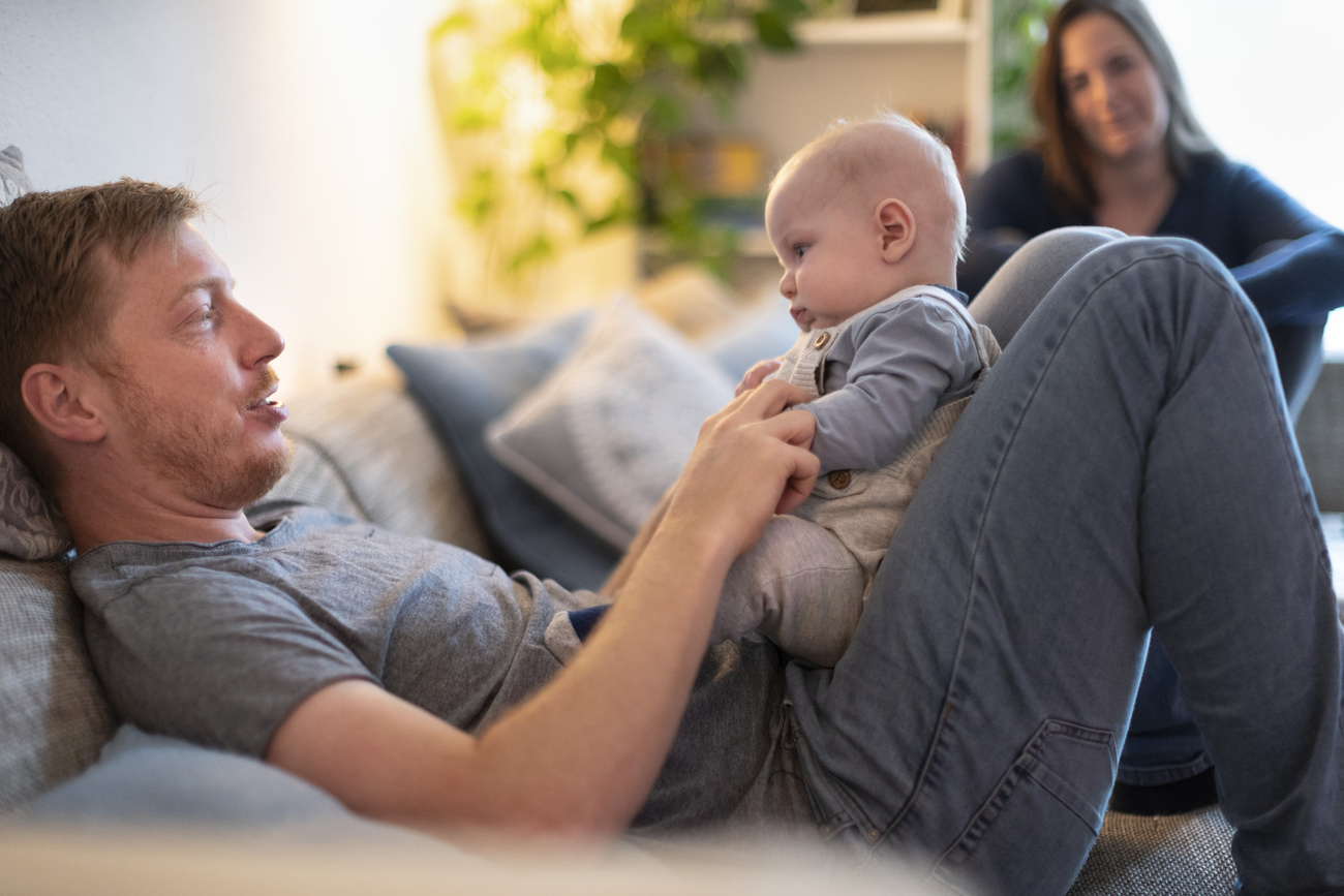 A father holding a baby in his lap