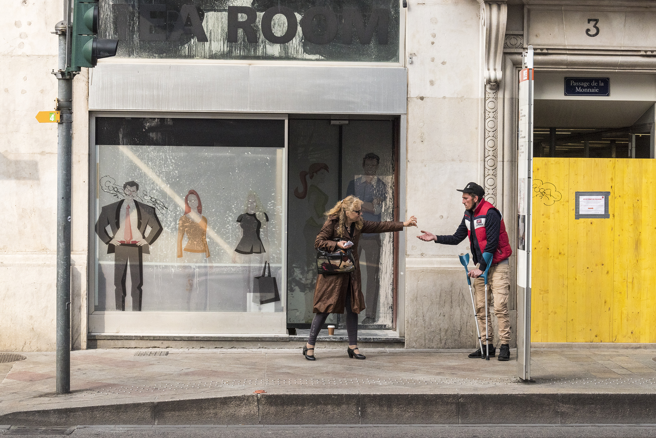 women helps a beggar from distance