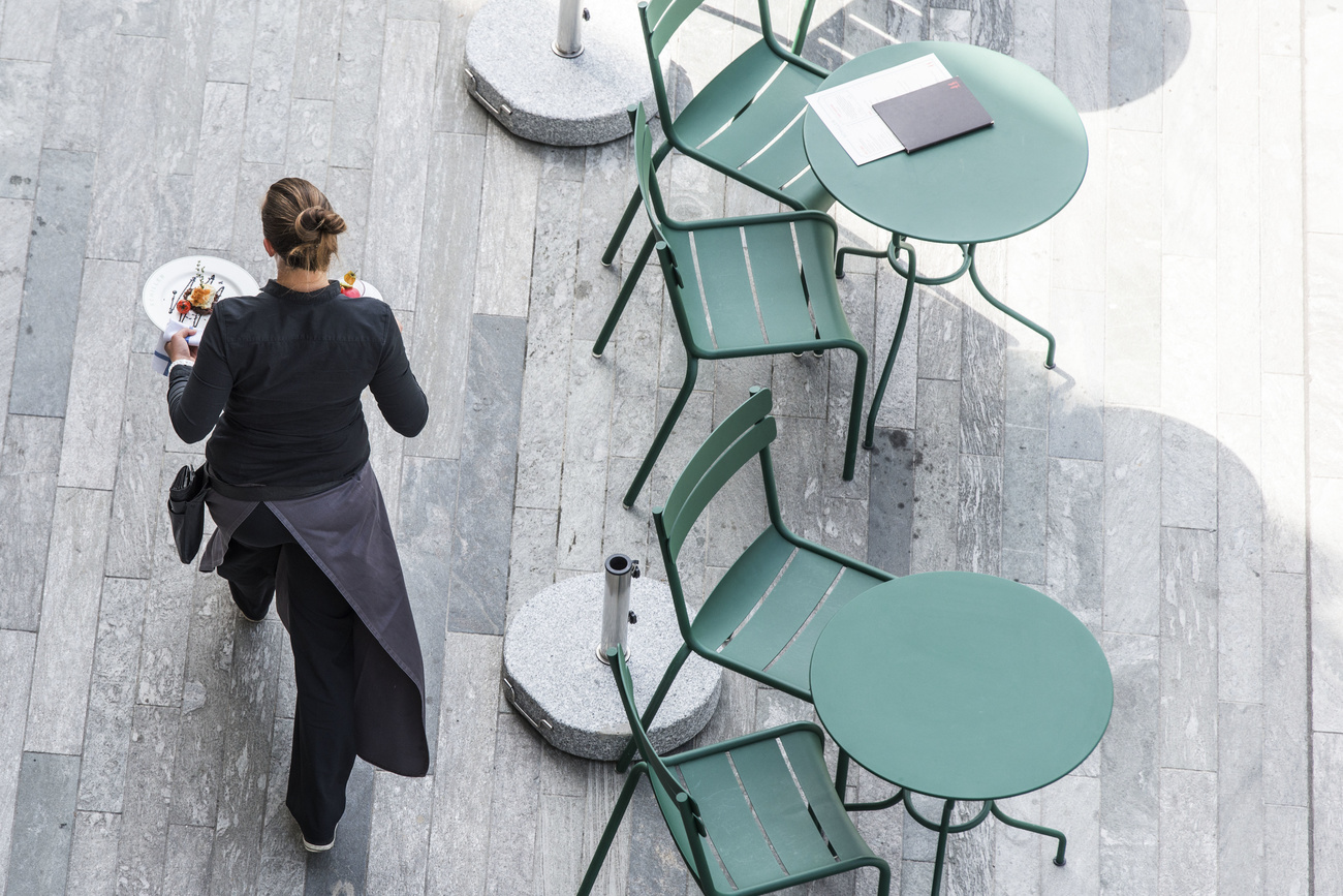 Waitress among empty tables