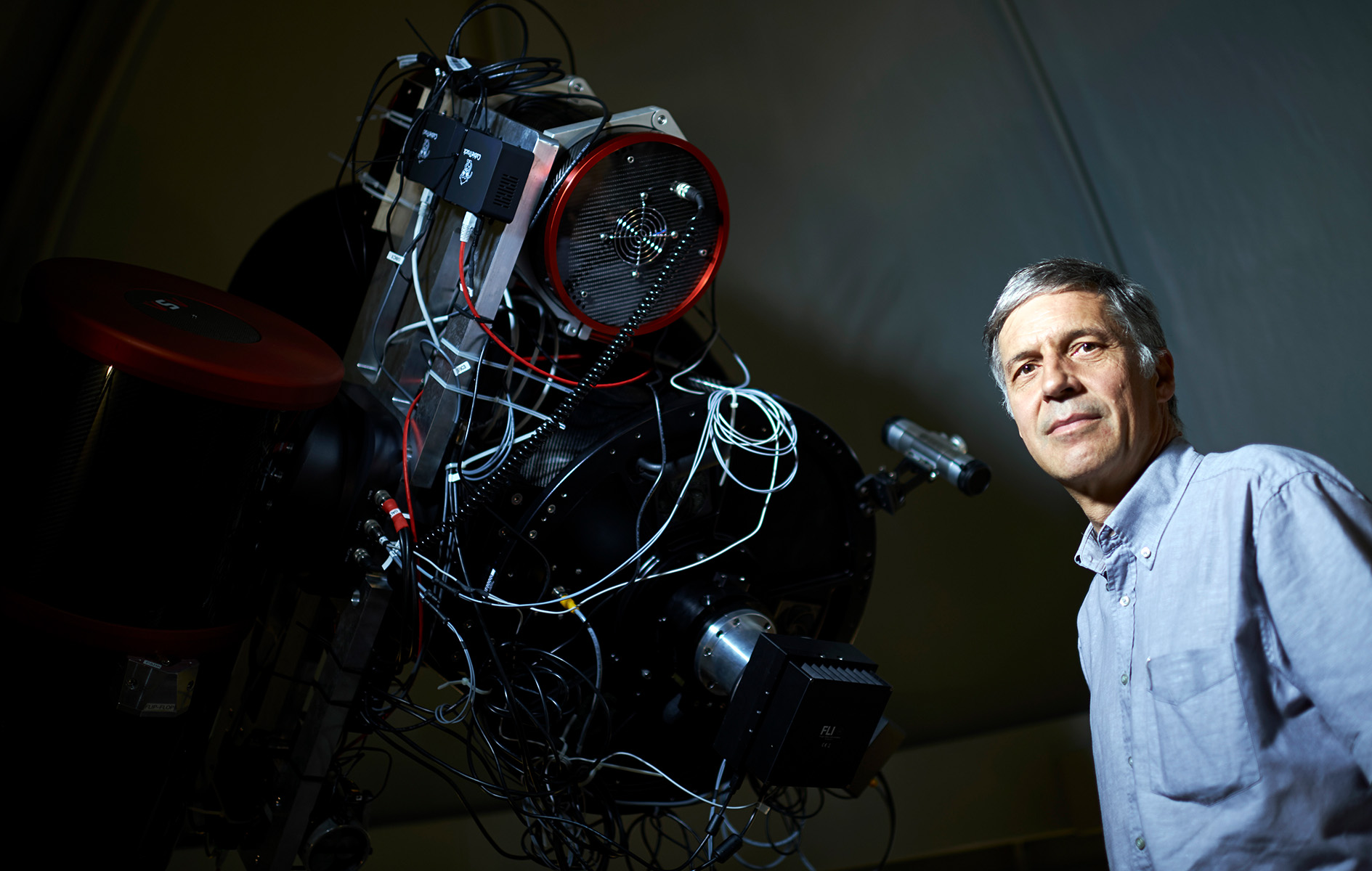 Man standing next to a large piece of equipment