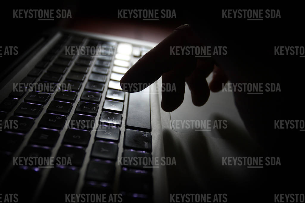 Hand poised over computer keyboard