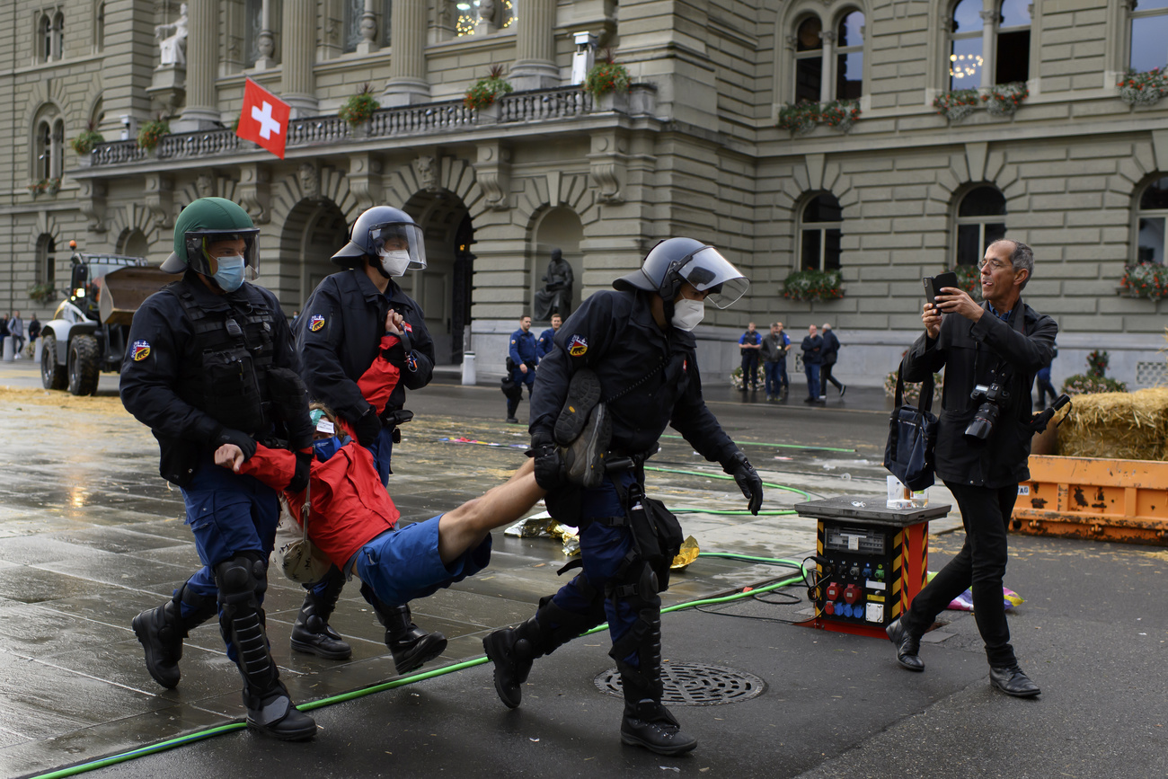 Police carrying away a protestor