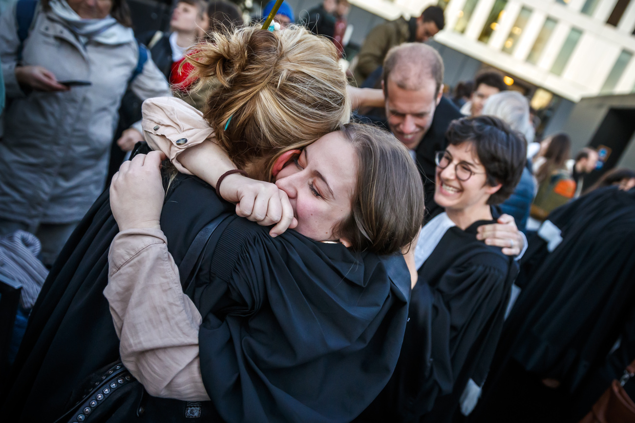 Two people hug in a crowd