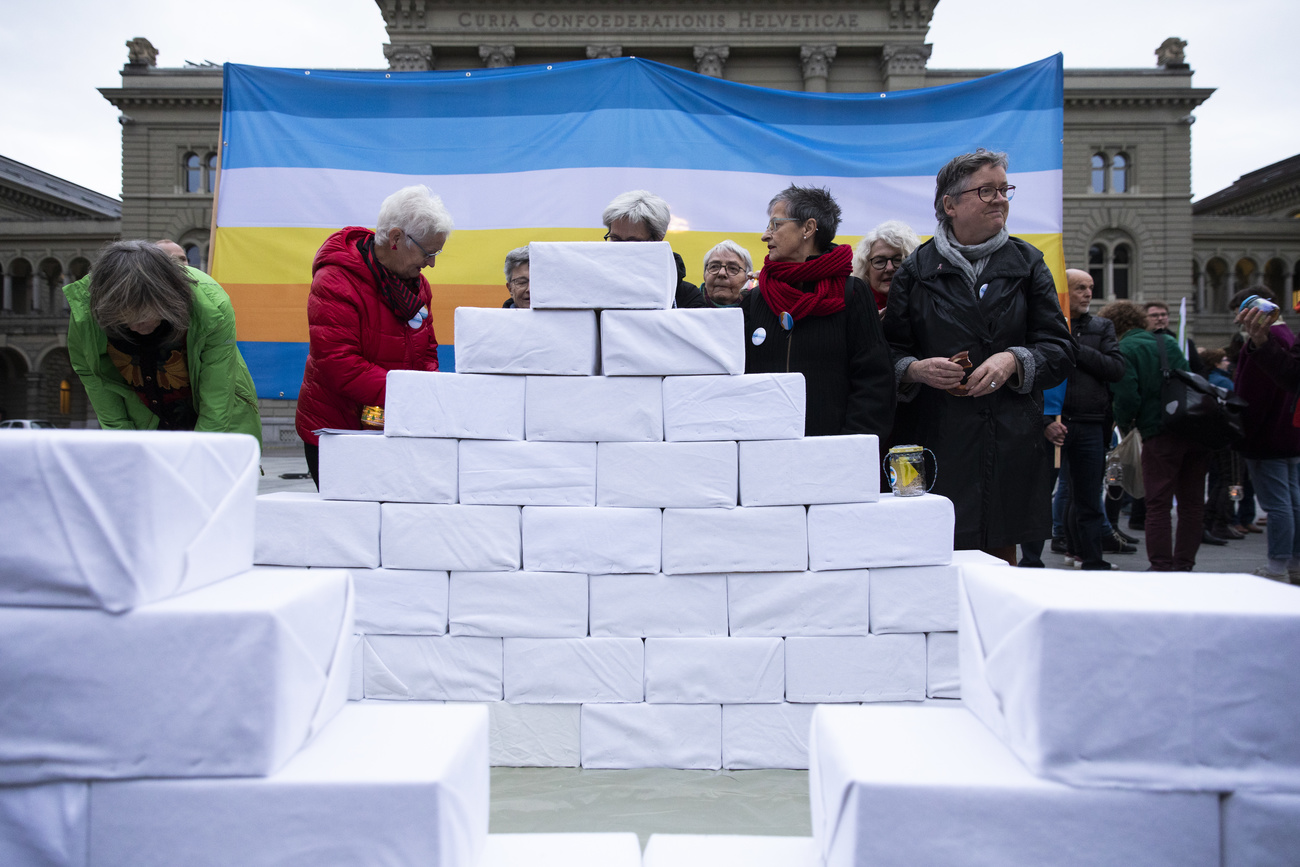Campaigners with white boxes piled up like snow blocks