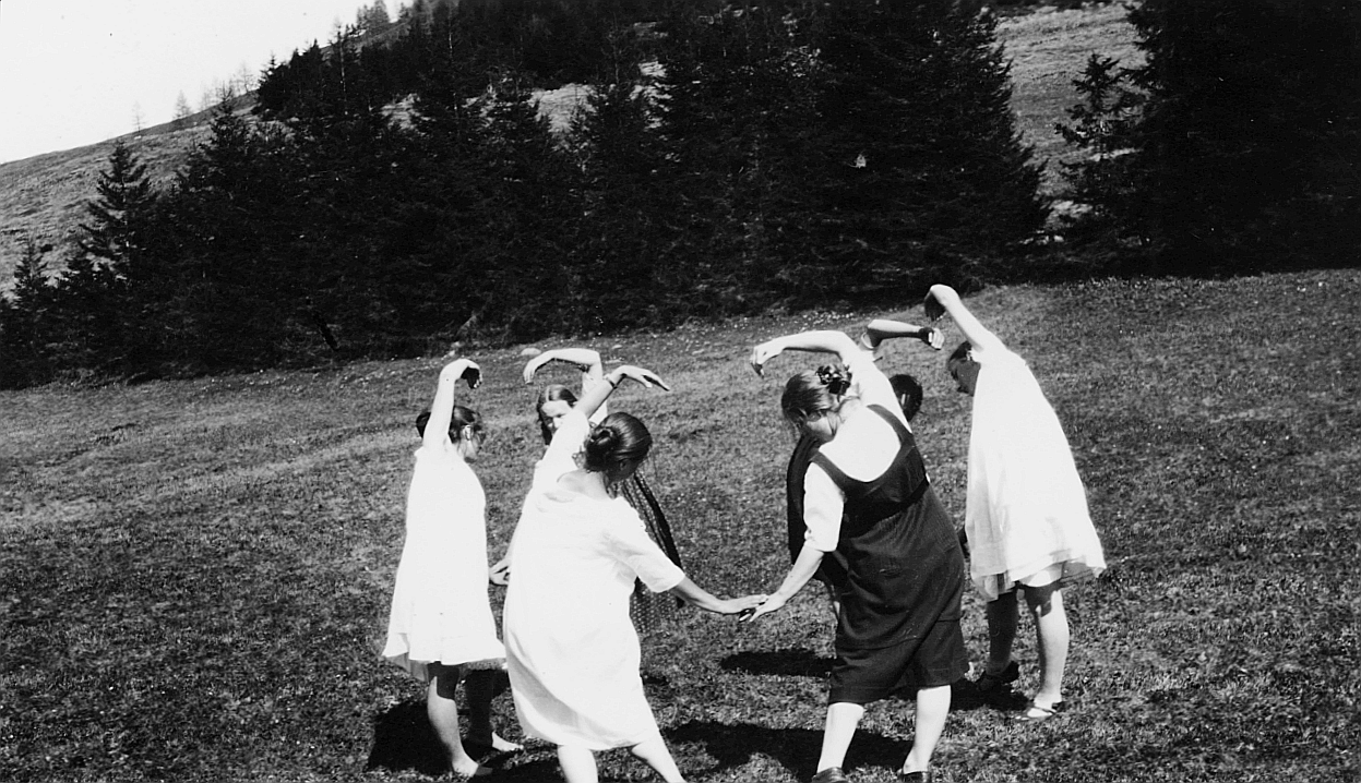 Three young girls dressed in white.