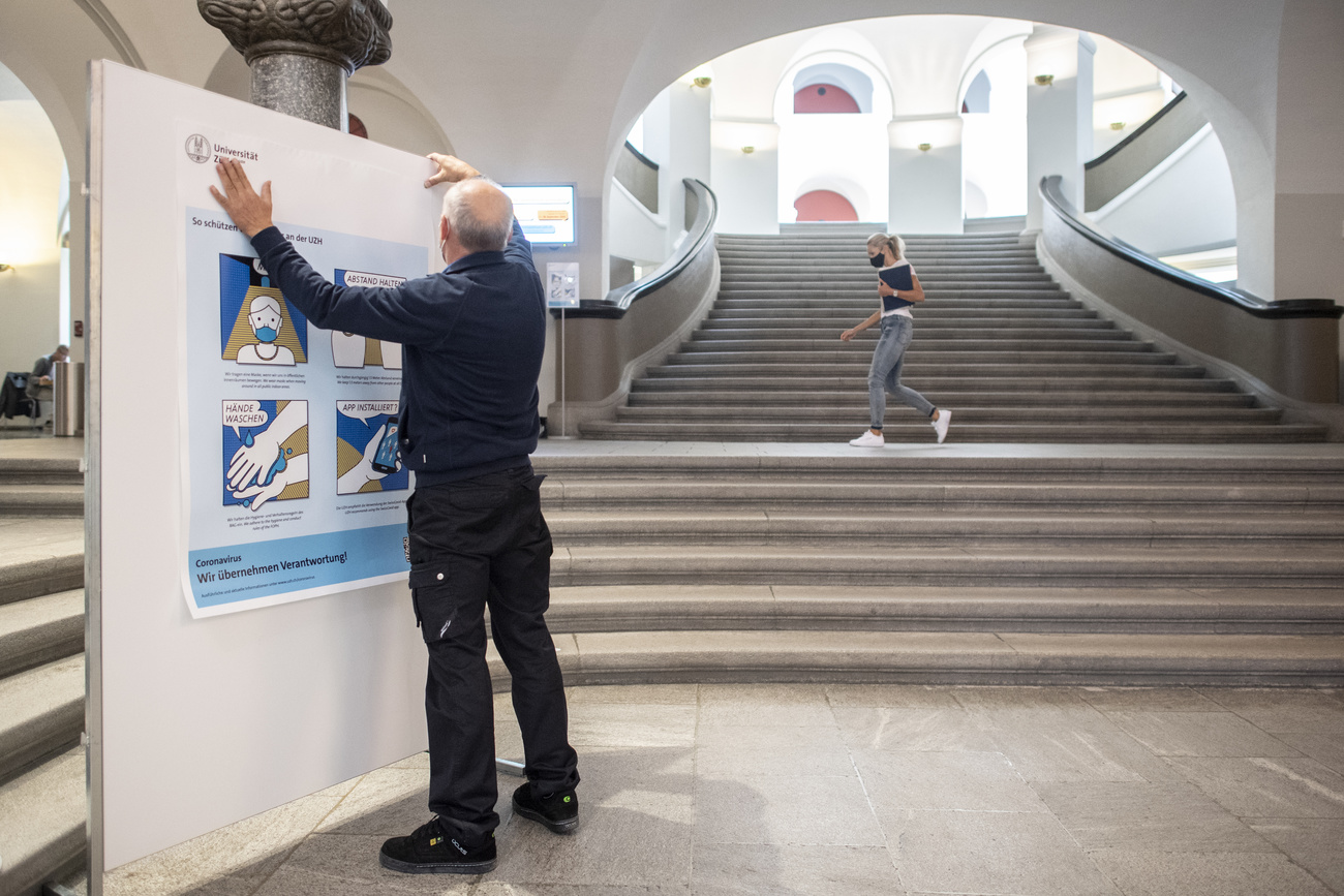 Man puts up poster on Covid measures at University of Zurich
