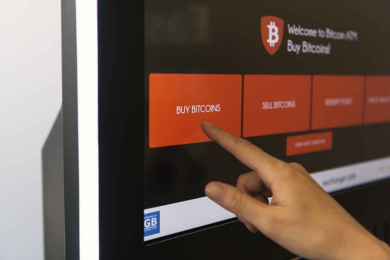 Person buying bitcoin from an ATM