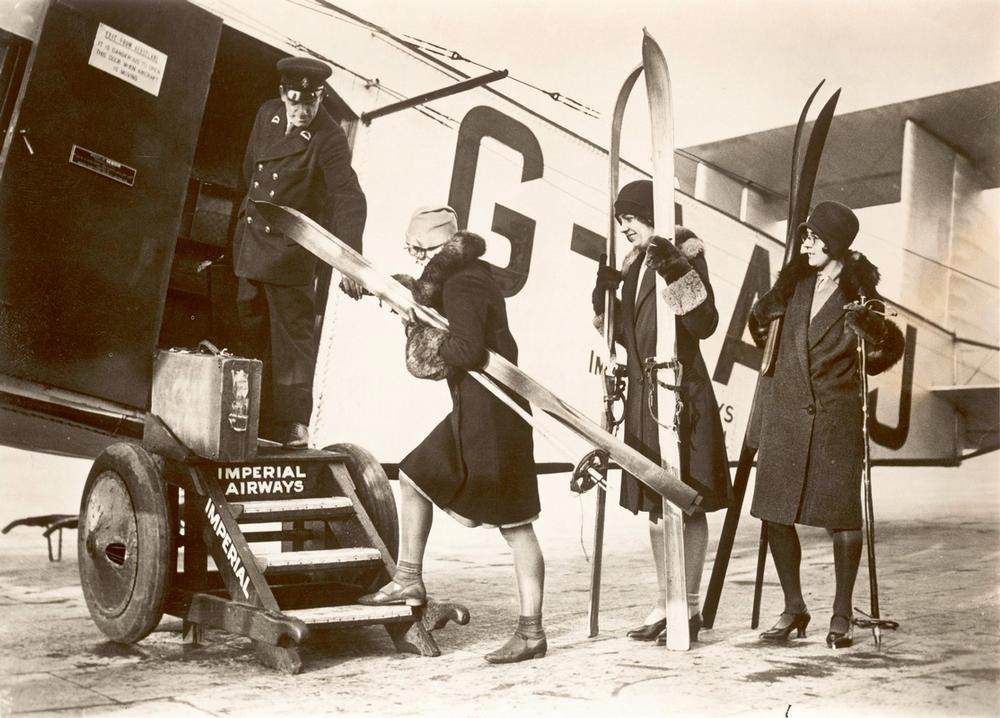 Women board aircraft with skis