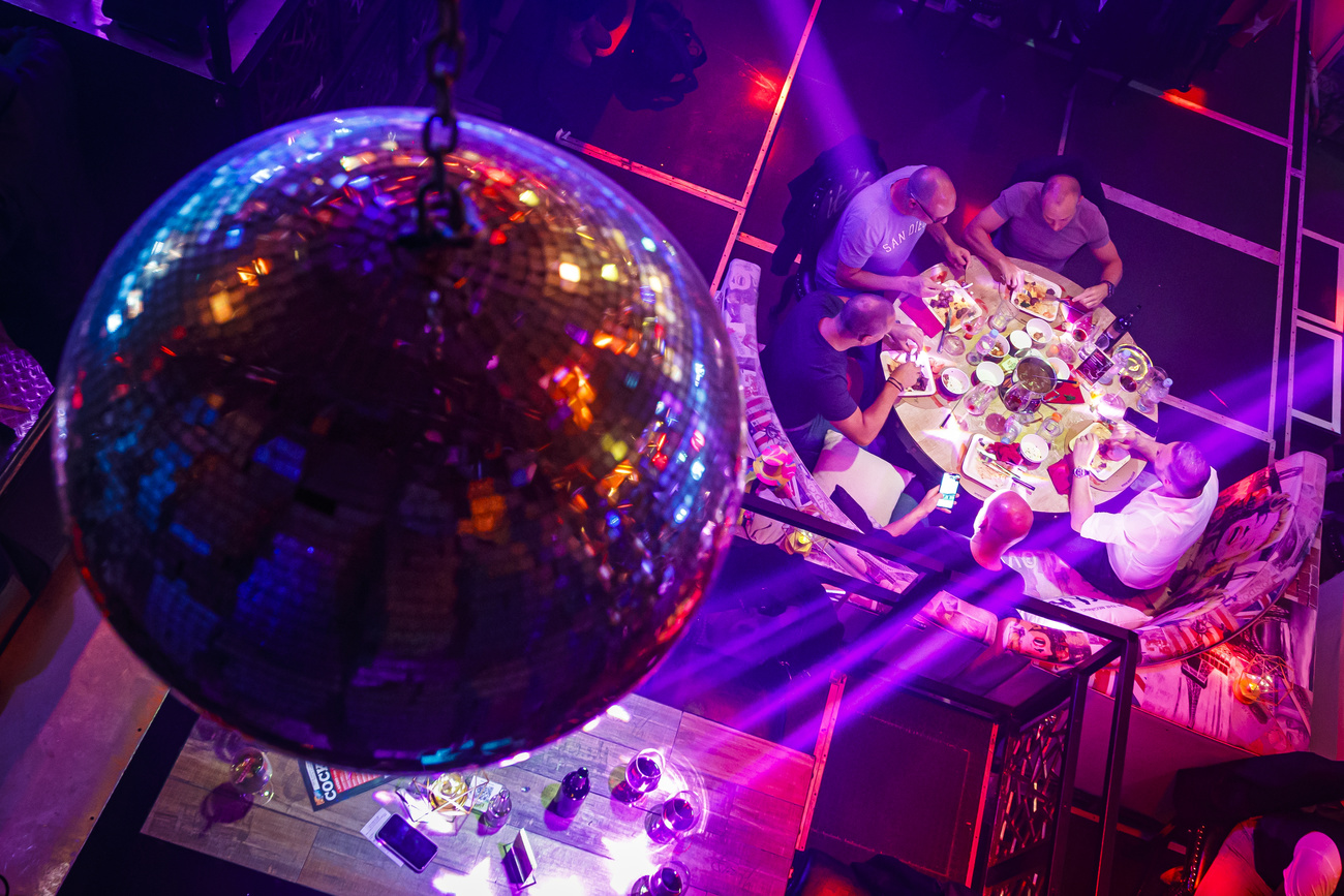 People eating seated at nightclub