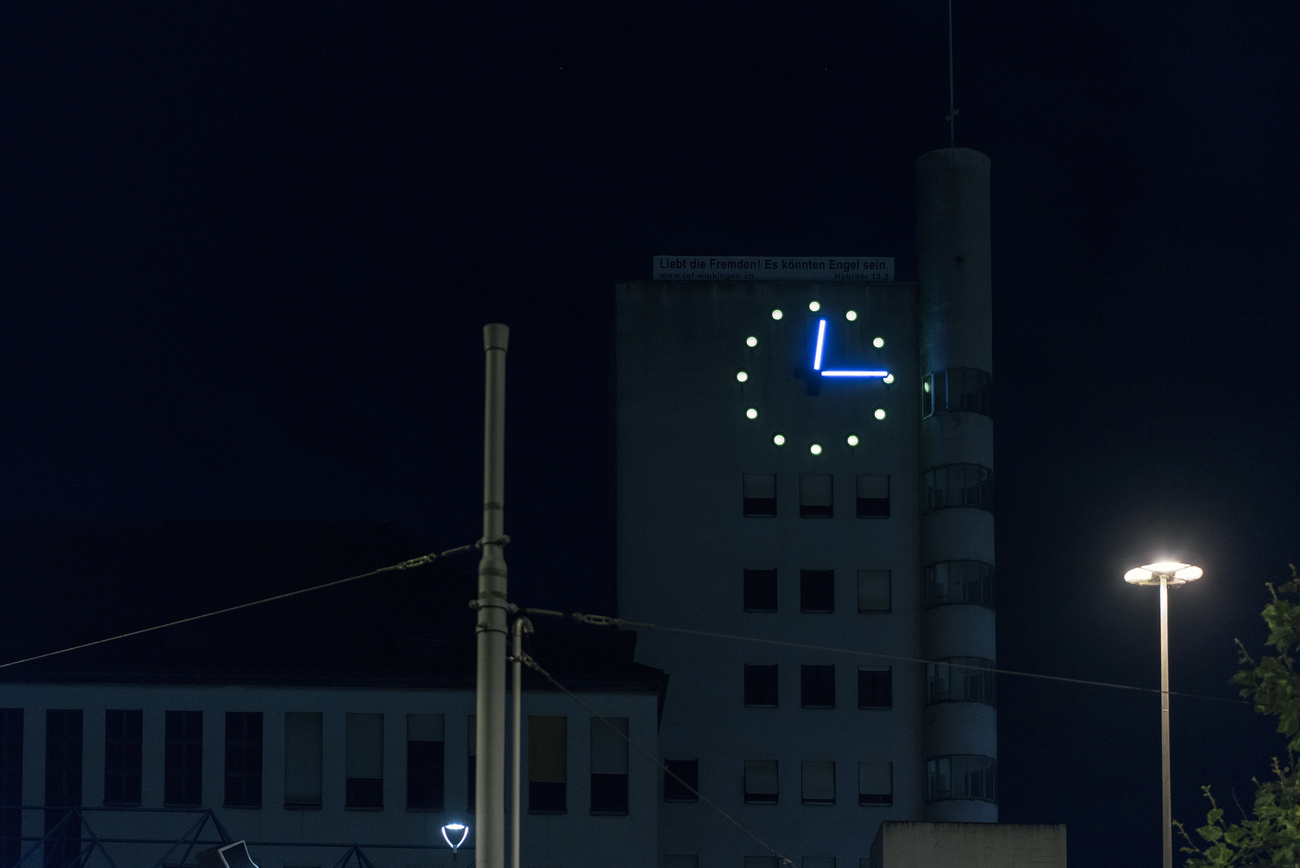 Illuminated clock on a tower at night