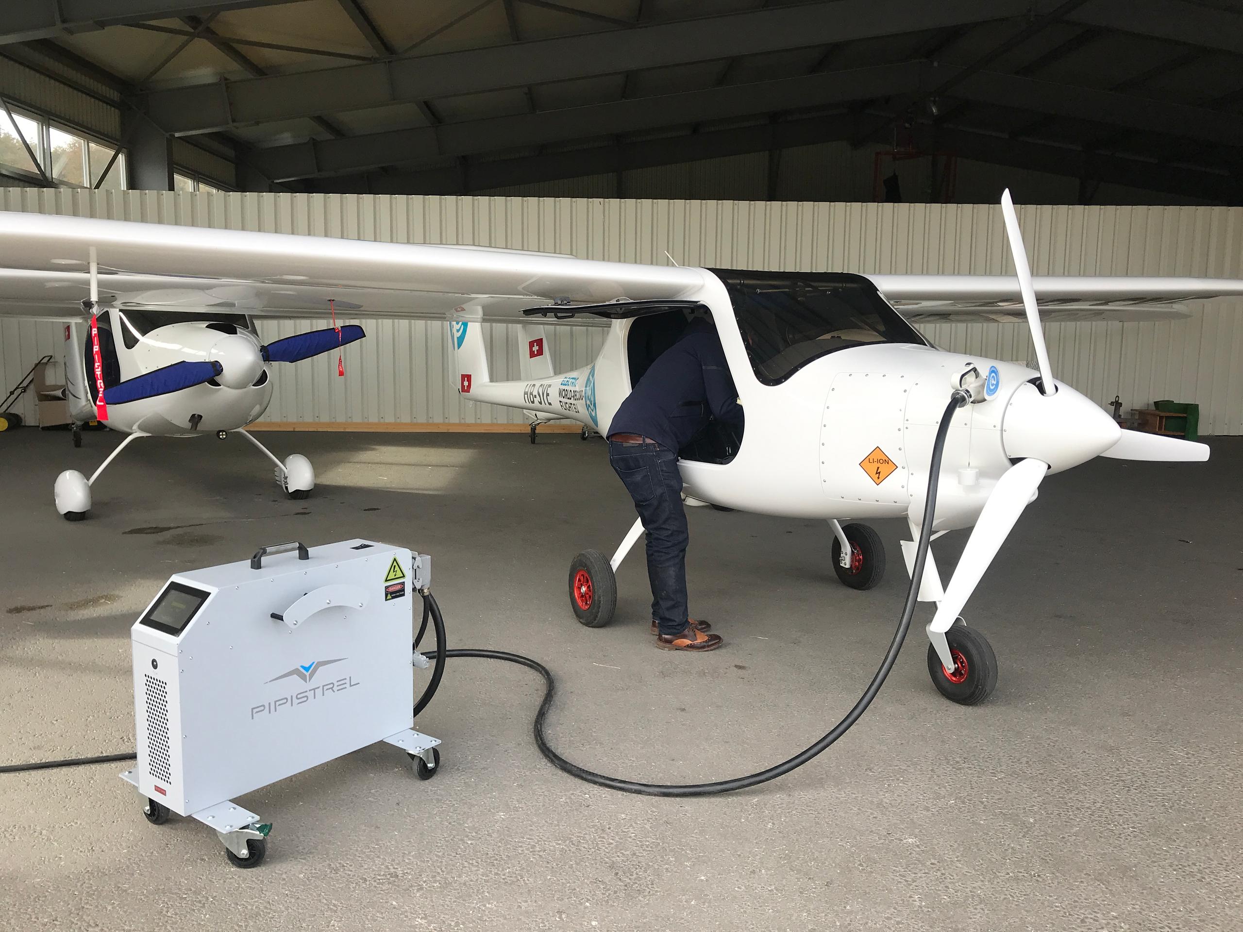 Man looking inside electric plane.