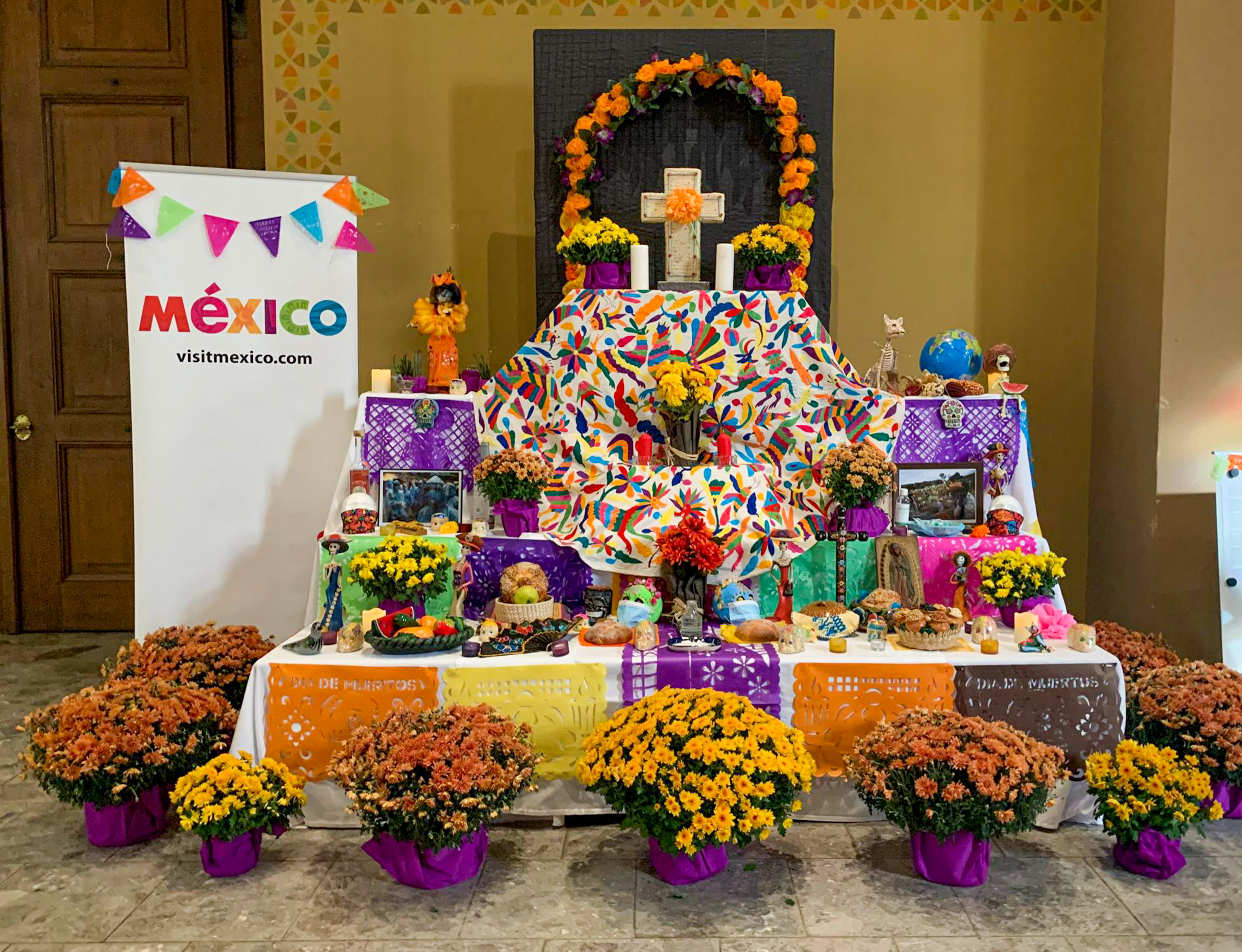 Ofrenda de muertos con velas, flores y alimentos