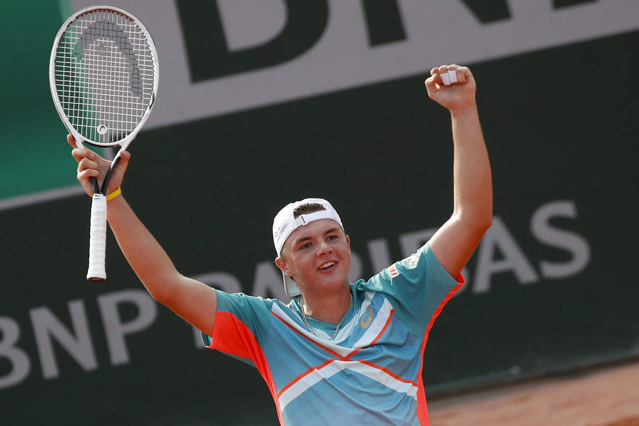 Stricker raises racquet in victory