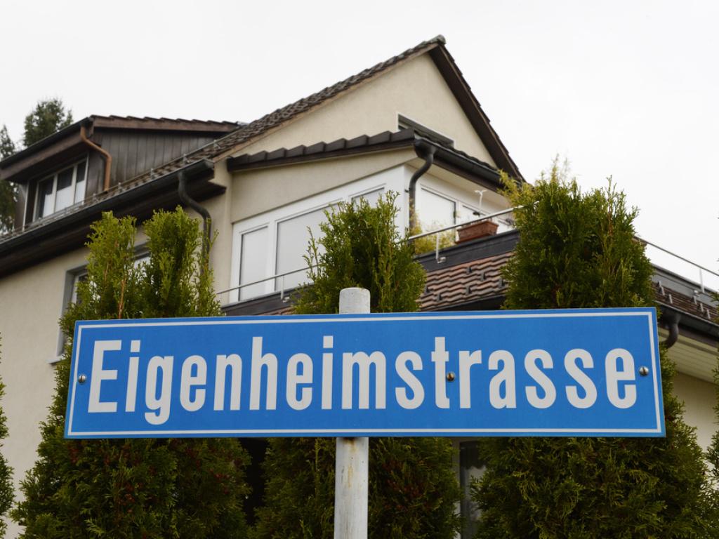 Ein Haus vor einer Strassetafel "Eigenheimstrasse"
