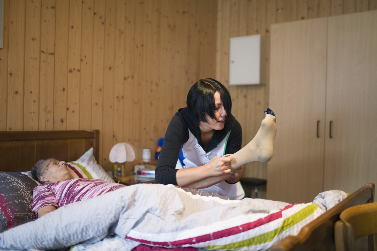 Elderly woman in bed and nurse