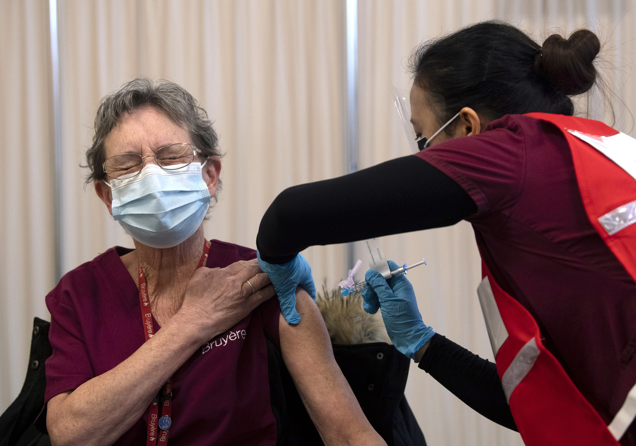Woman looking pained as she gets a jab