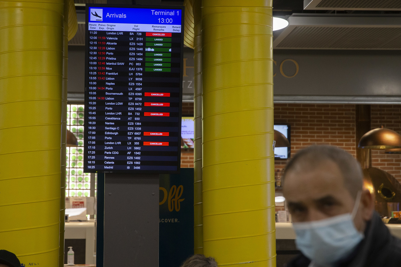 Screens are listing the cancelled flights between Switzerland and Britain