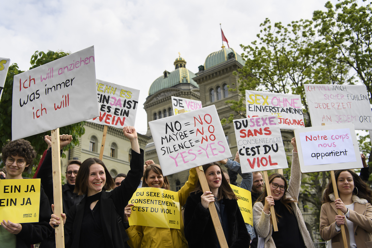 Campaigners protest outside the Federal Parliament in Bern.