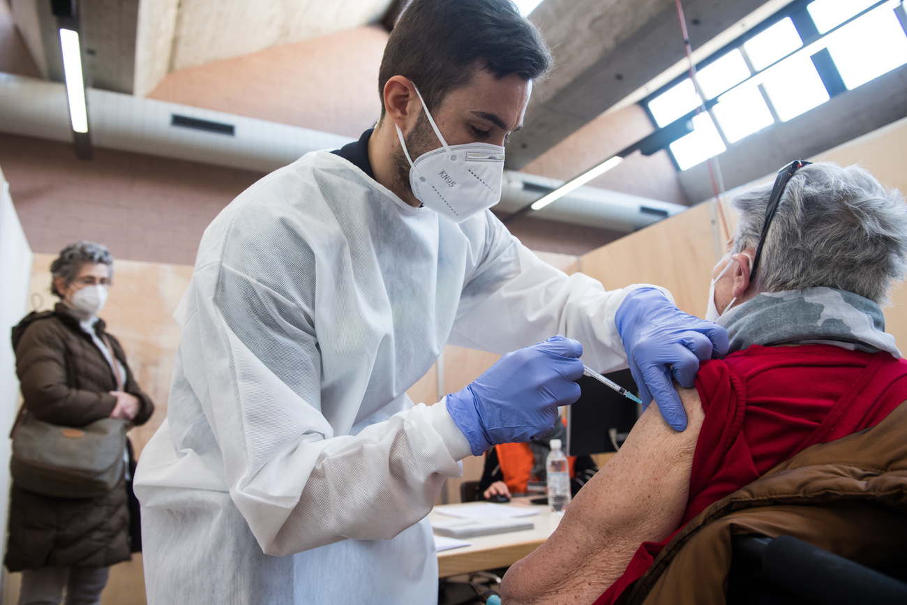 An elderly woman gets vaccinated against Covid-19 at a centre in Rivera, canton Ticino, on January 12, 2020.