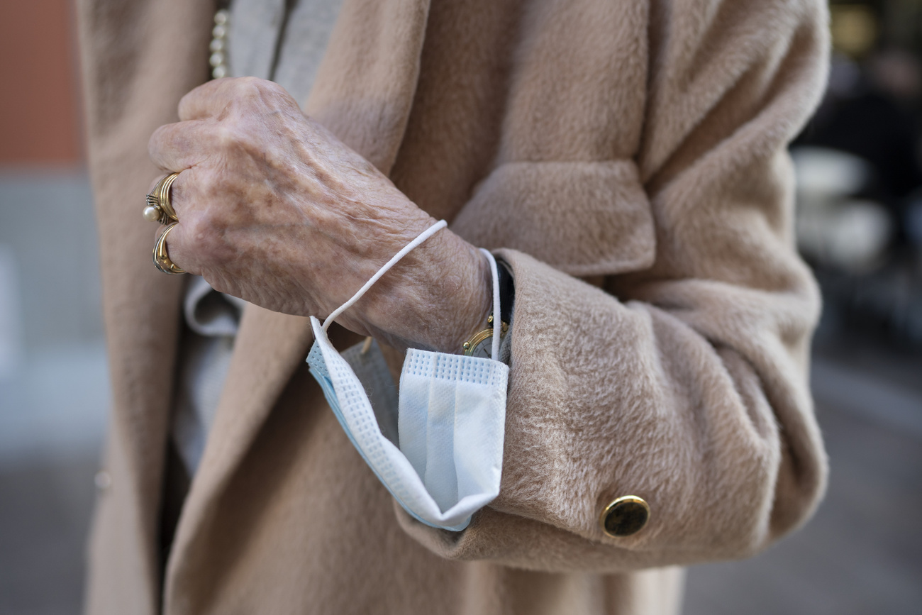 Woman with mask around wrist