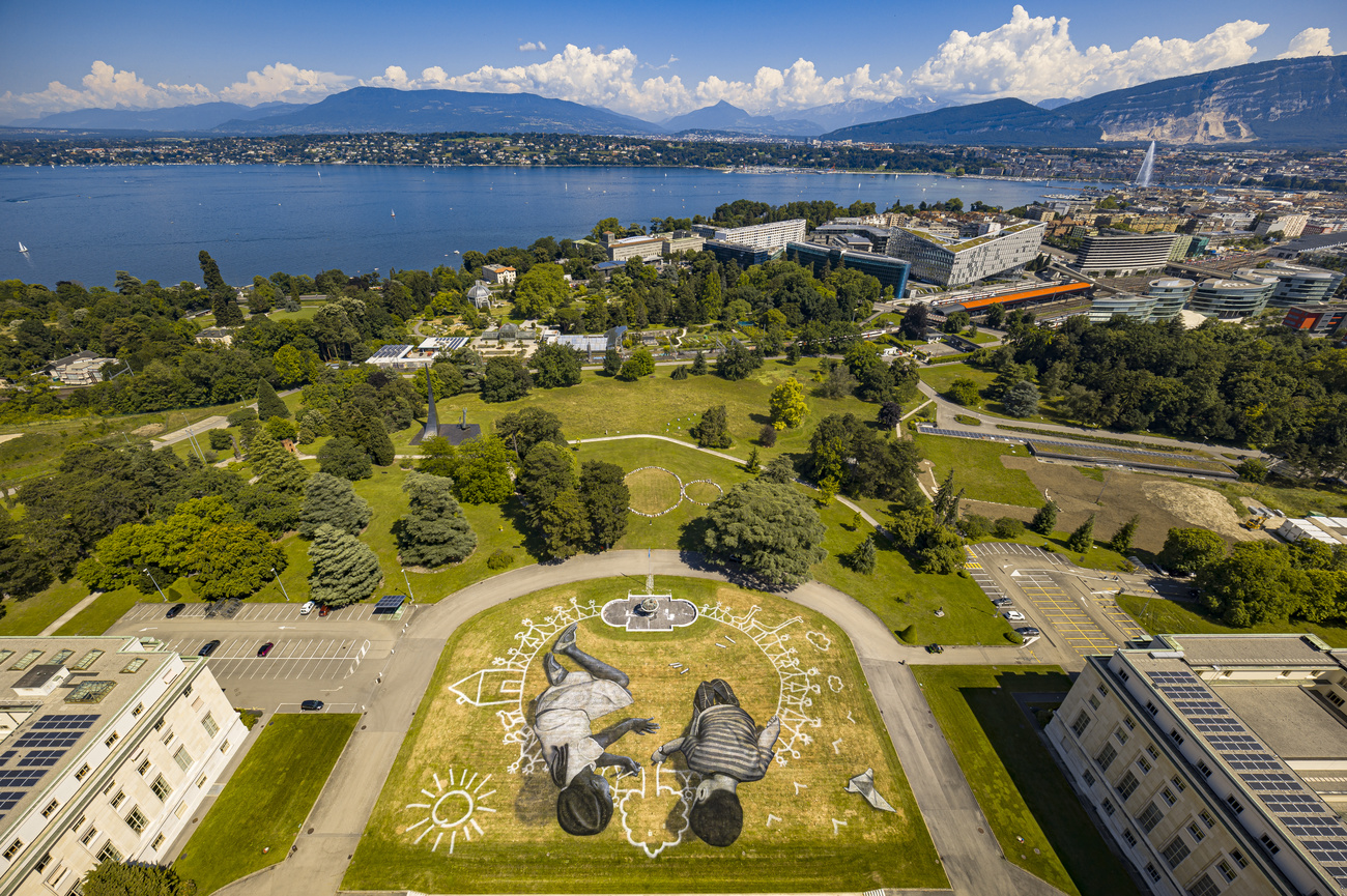 Landscape with city, lake and giant painting of children