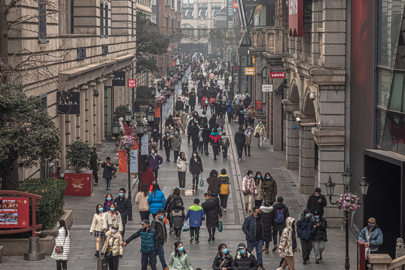 Una via del centro di Wuhan pieno di gente presa a un anno esatto dal lockdwn