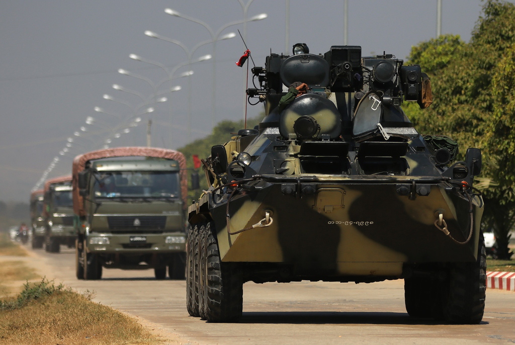 Military vehicles and soldiers patrol a road in Naypyitaw, Myanmar