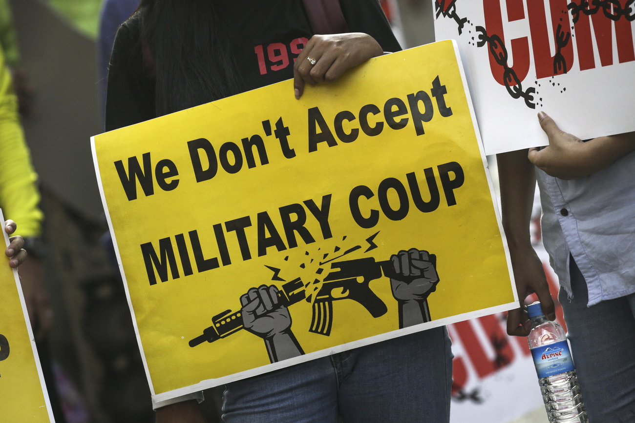 A demonstrator holds a placard during a protest against military coup in Yangon, Myanmar,