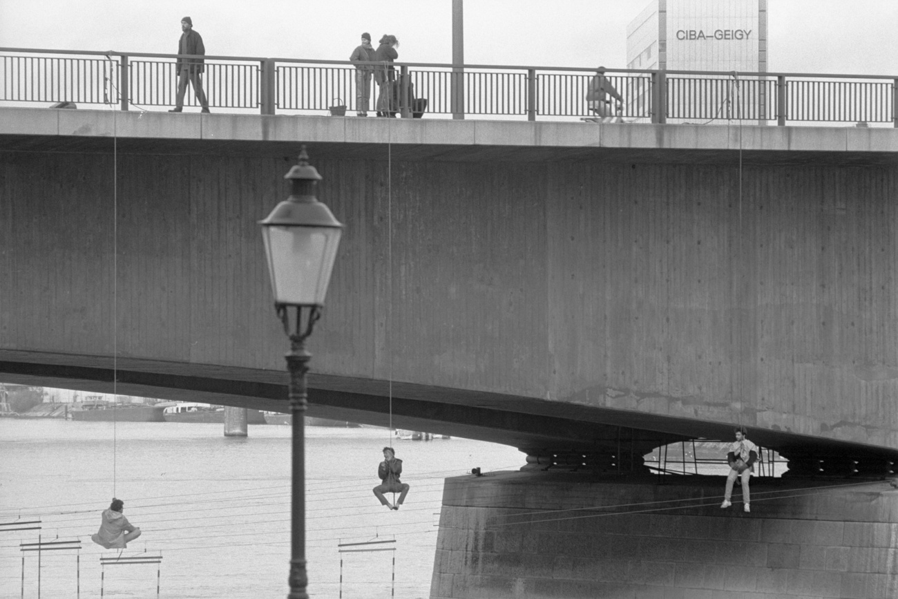 Jeune homme suspendu à un pont.