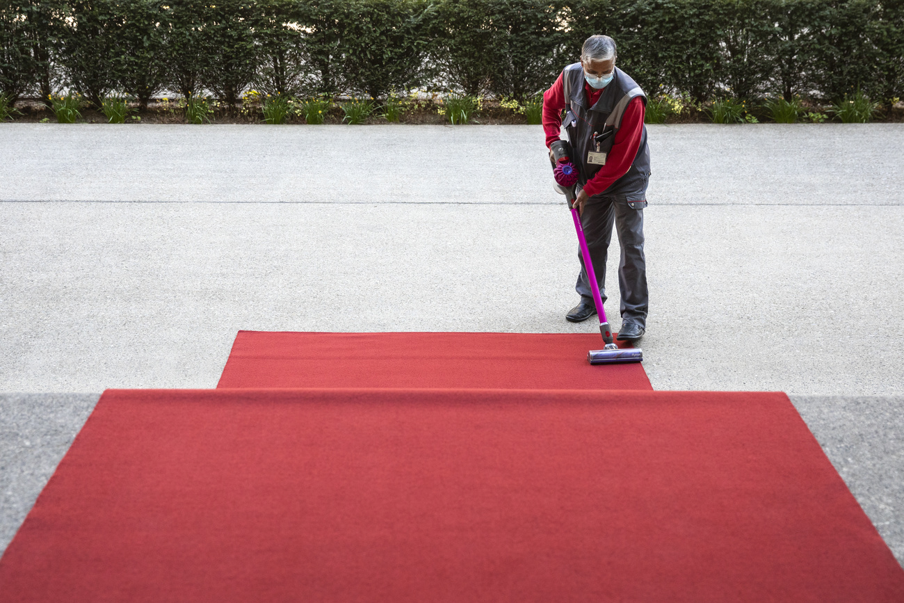Man sweeps red carpet