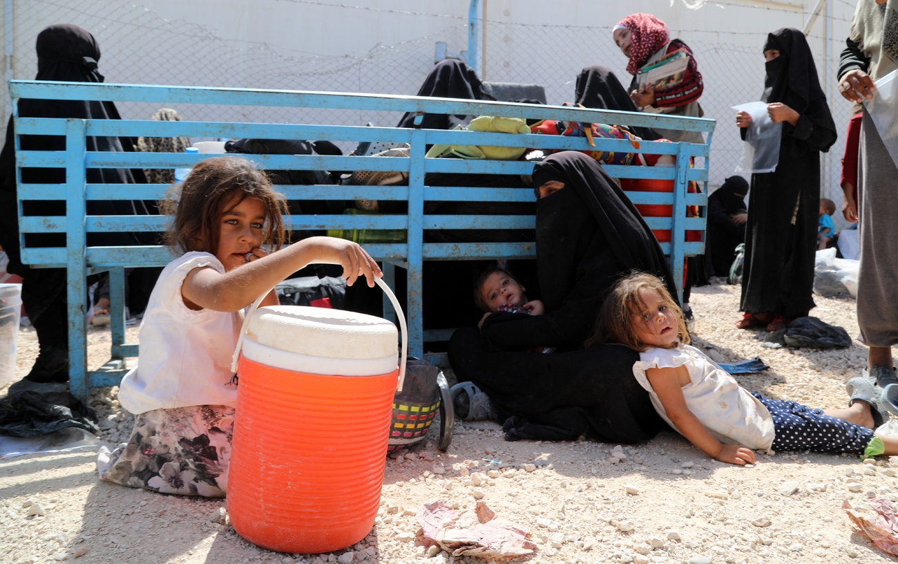 The wife of an ISIS fighter and her children in a Kurdish-run camp in northeast Syria