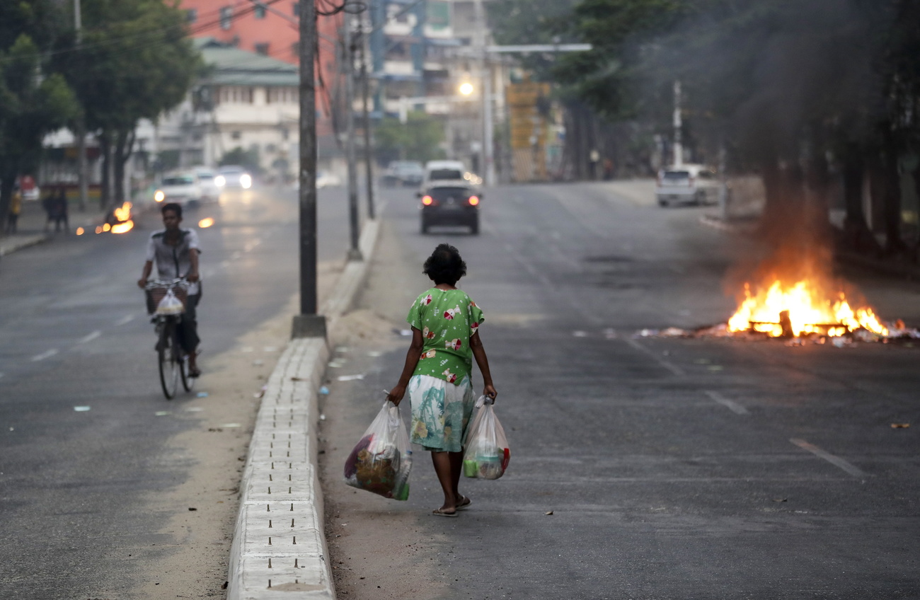 Woman walking down a street in Myanmar