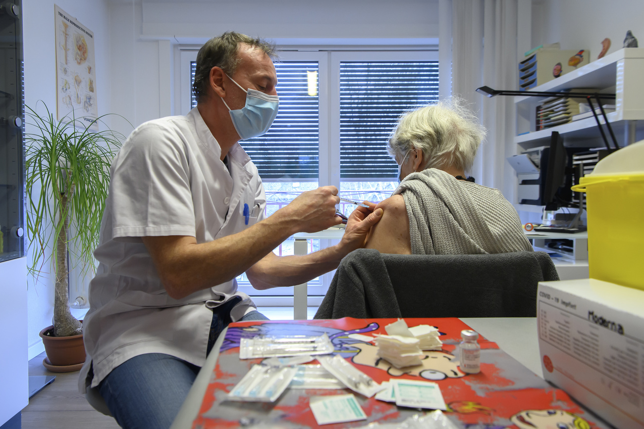 Doctor giving vaccine to patient