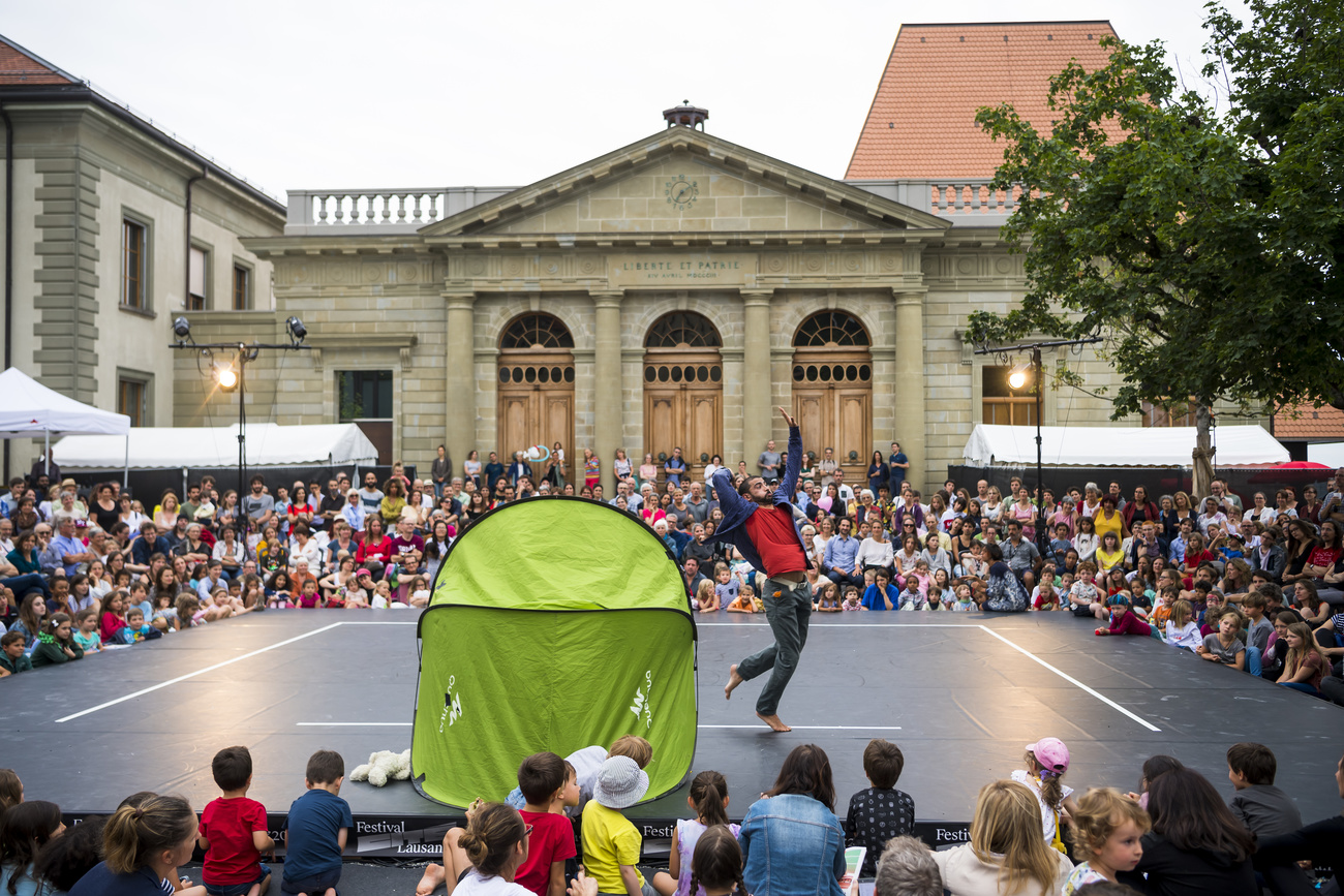 Artist on outdoor stage with spectators