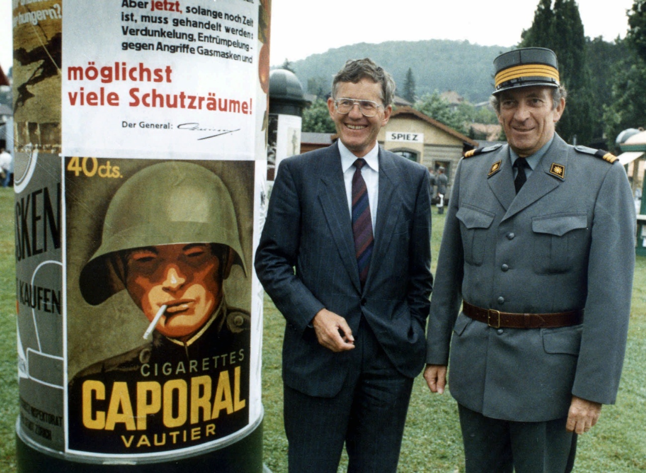 Dos hombres junto a un pilar publicitario