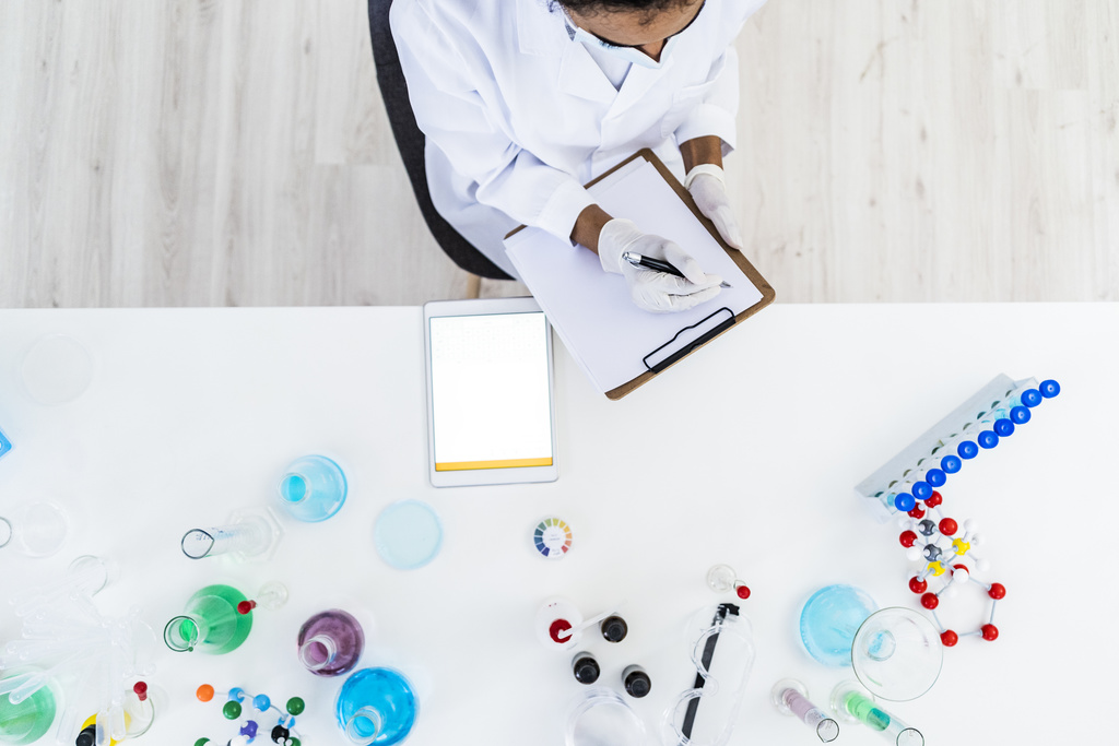 Scientist with notes, view from above.