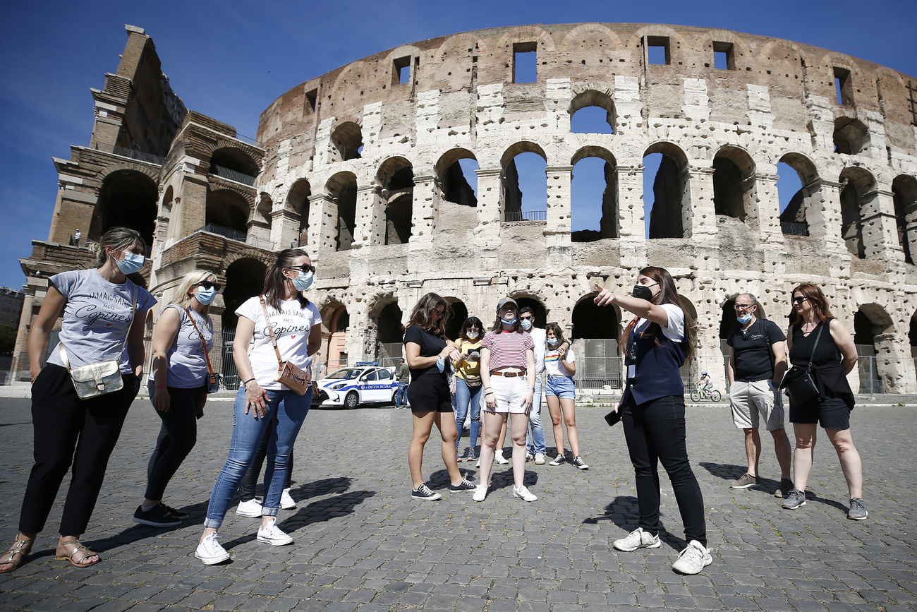Turisti davanti al Colosseo di Roma.
