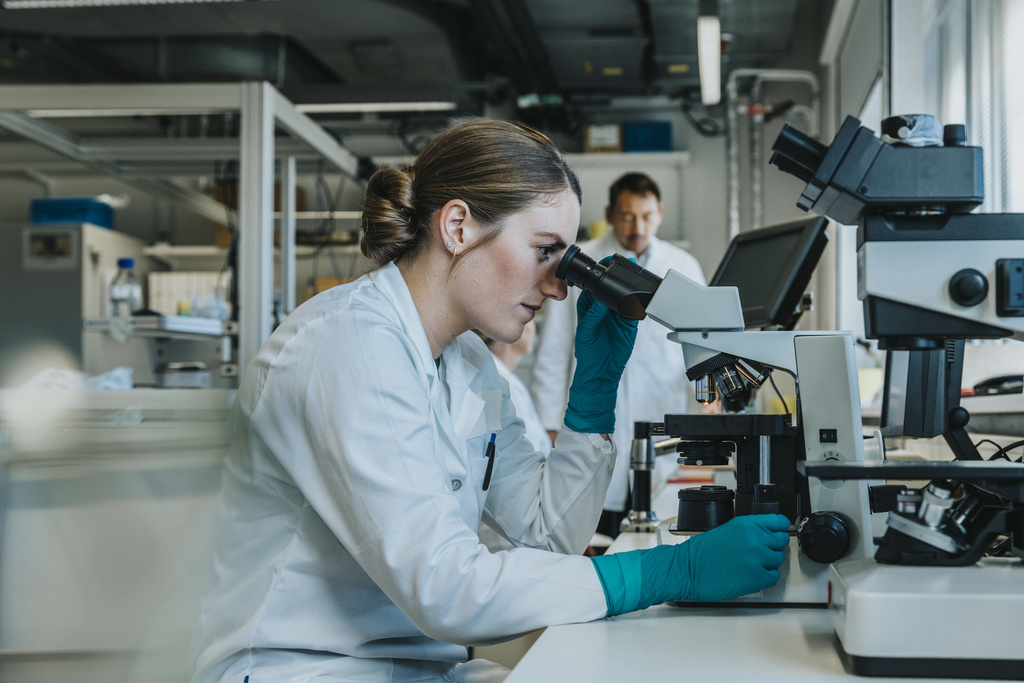 Women looking through microscope