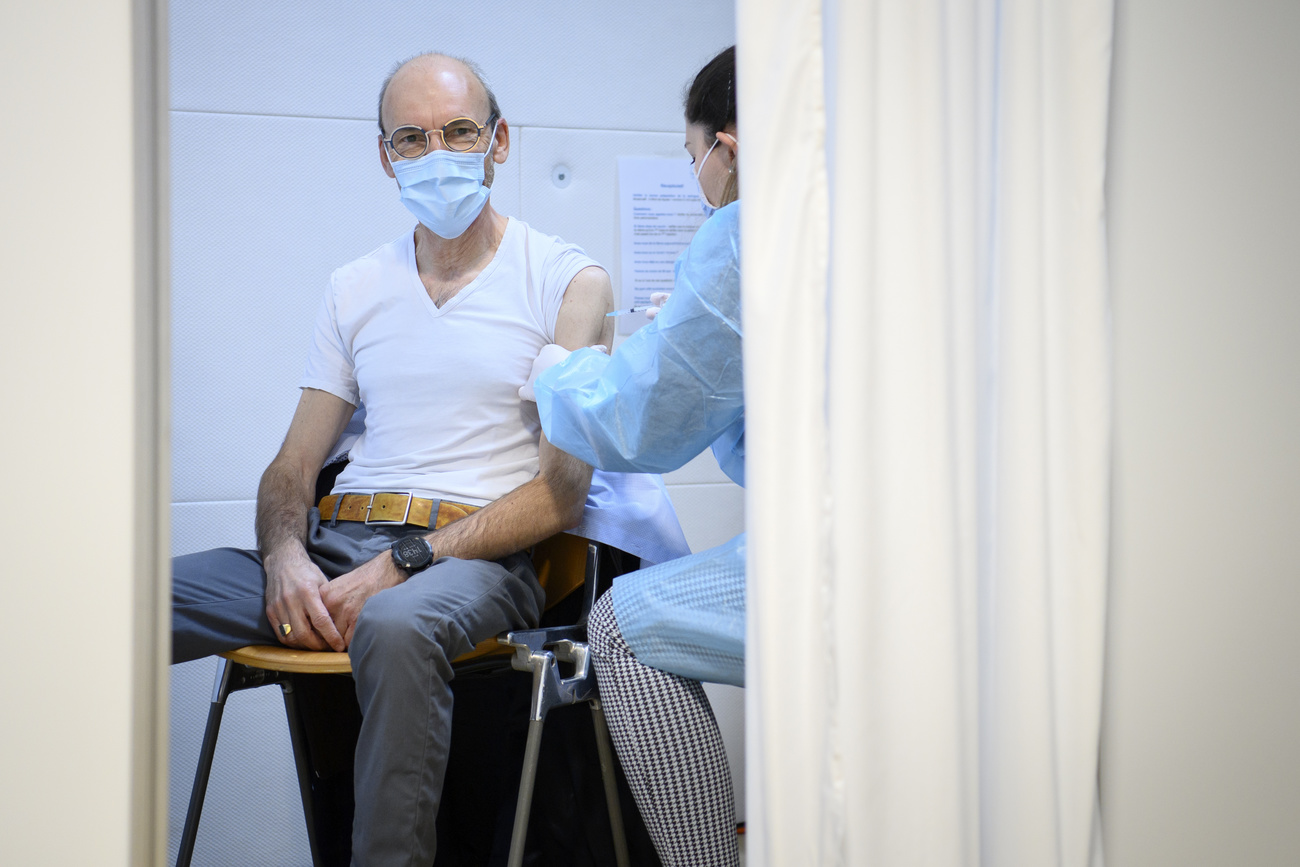 Nurse applying a jab to a man